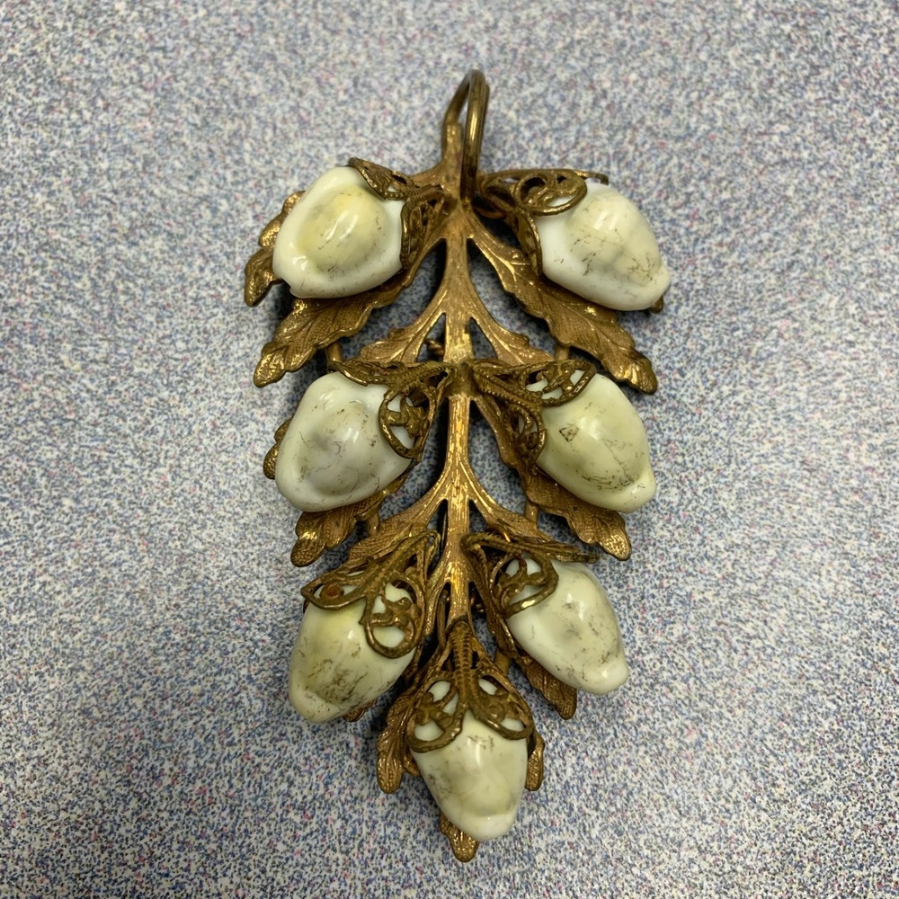 This is an early Miriam Haskell gold gilt sea shell filigree pin pendant